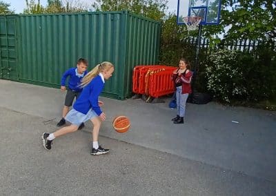 Children playing basketball in the yard