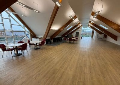 The events room laid out with tables and chairs, windows along the whole of one side