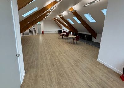 The events room, its open wooden floor running down to tables and chairs at the far end