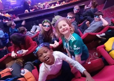 Children wearing 3D glasses in the theatre on a playscheme trip