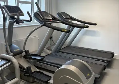 Treadmills and a cross trainer beside the window in the NY&CI gym