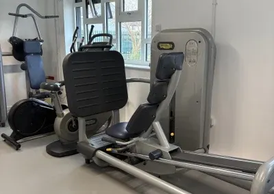 A leg press and other resistance machines in the gym