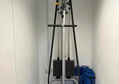 A cable weights machine in the corner of the gym
